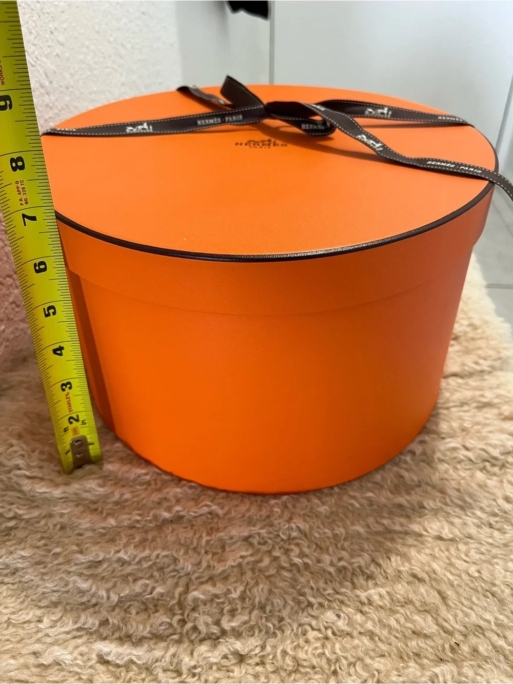 Original Hermès Orange Round Hat Box with branded brown ribbon